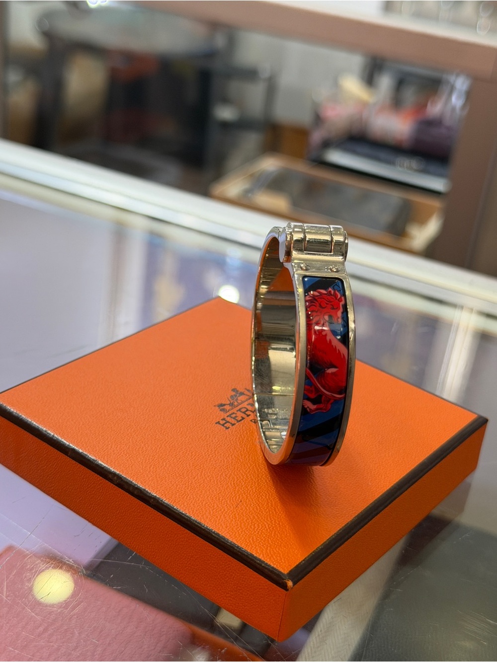 Hermes Silver Cuff Bracelet with Red and Blue Enamel Lion Motif